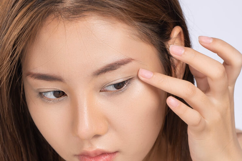 A Woman Looking At Her Brow Area In DCH Treatment Information